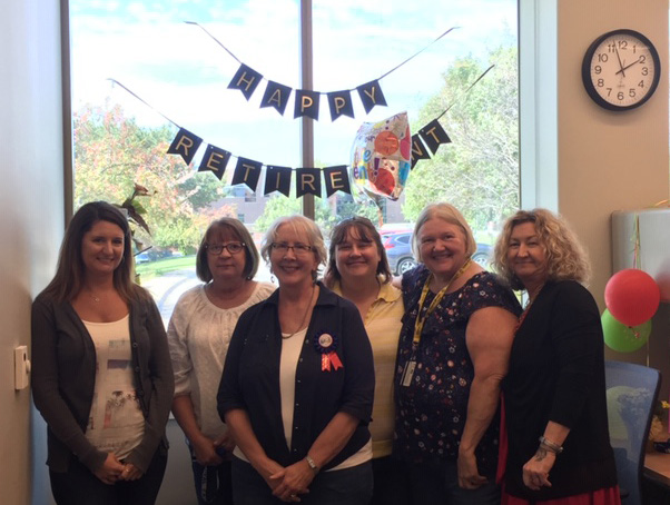 Office staff pose with Ann Heptig at retirement party